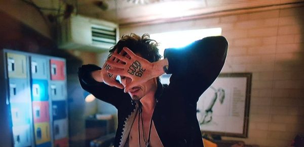 Klaus from Umbrella Academy with Good Bye Tattoo on his hand